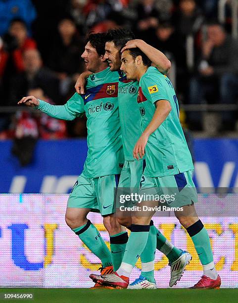 David Villa of FC Barcelona celebrates with his team-mates Lionel Messi and Pedro Rodriguez after scoring his second team's goal under a challenge of...