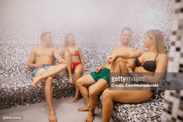 two young couples relaxing in steam bathroom or sauna - casa de banhos públicos imagens e fotografias de stock