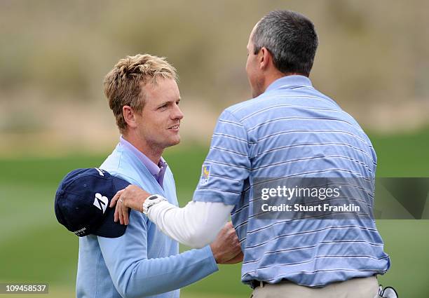 Matt Kuchar congratulates Luke Donald of England on his victory on the 13th hole during the semifinal round of the Accenture Match Play Championship...