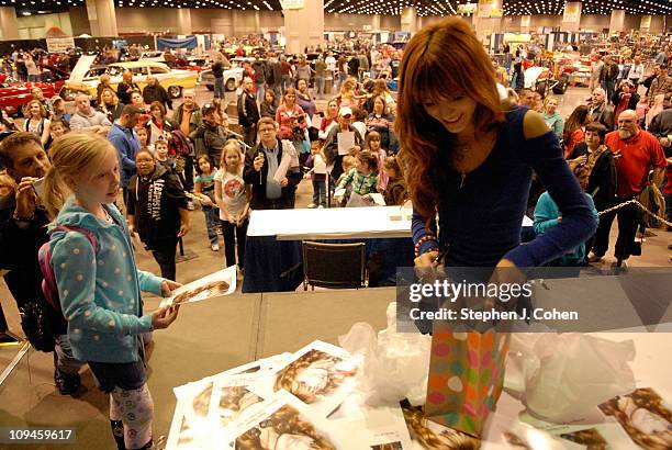 Bella Thorne receives a gift from a fan during the 48th Annual Carl Casper's Custom and Louisville auto show at theKentucky Exposition Center on...