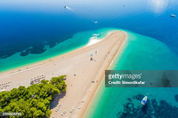 aerial view of beach on peninsula in croatia, bol, zlatni rat - croatia stock pictures, royalty-free photos & images