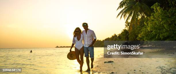 view of pair walking in water,maldives - sandbar stock pictures, royalty-free photos & images