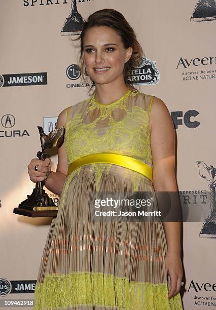 Actress Natalie Portman, winner of the Best Female Lead award for 'Black Swan', poses in the press room during the 2011 Film Independent Spirit...