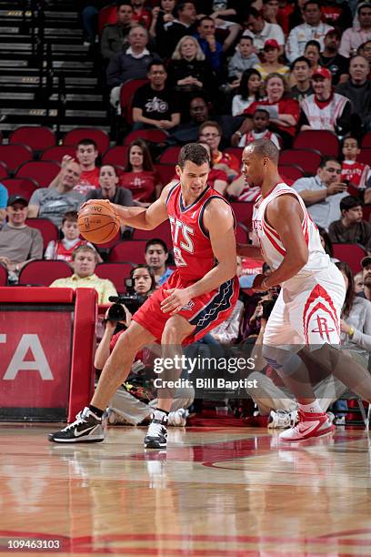 Kris Humphries of the New Jersey Nets drives the ball past Chuck Hayes of the Houston Rockets on February 26, 2011 at the Toyota Center in Houston,...
