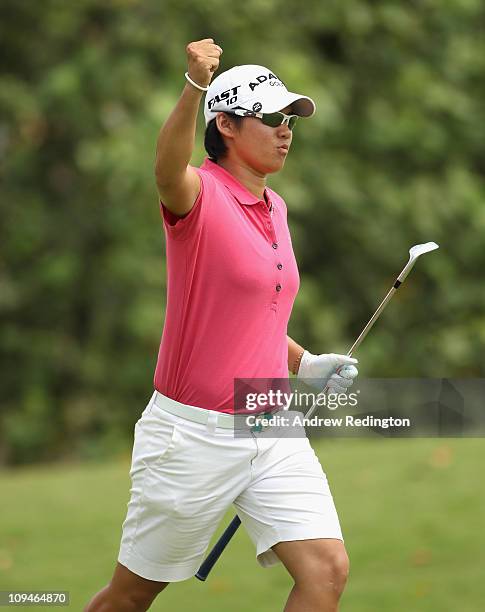 Yani Tseng of Taiwan celebrates after chipping in for a birdie on the sixth hole during the final round of the HSBC Women's Champions at the Tanah...