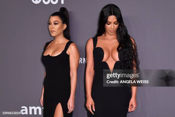 Media personalities Kourtney Kardashian and sister Kim Kardashian West arrive to attend the amfAR Gala New York at Cipriani Wall Street in New York...