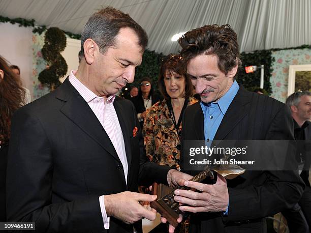 Philippe Leopold-Metzger, Piaget CEO, and John Hawkes, winner of the Best Supporting Male award for 'Winter's Bone', in the Piaget Lounge at the 2011...