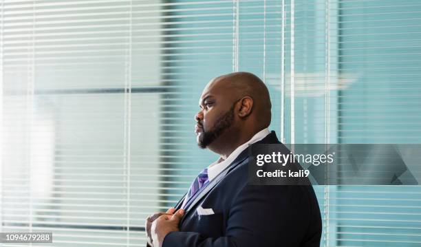 african-american businessman with large build, frowning - overweight 40 year old male concerned stock pictures, royalty-free photos & images