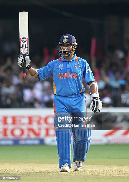Sachin Tendulkar of India reaches his century during the 2011 ICC World Cup Group B match between India and England at M. Chinnaswamy Stadium on...