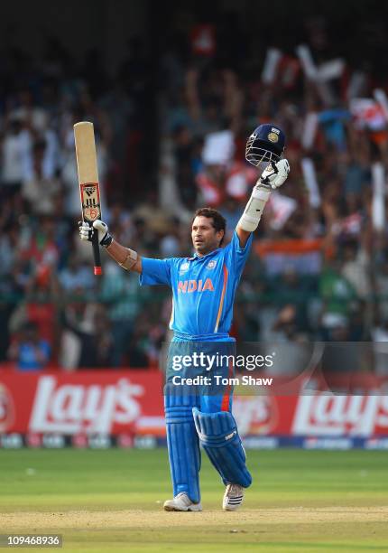 Sachin Tendulkar of India celebrates reaching his century during the 2011 ICC World Cup Group B match between India and England at M. Chinnaswamy...