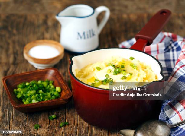 mashed potato in cooking pan on wooden background, copy space - potato masher ストックフォトと画像