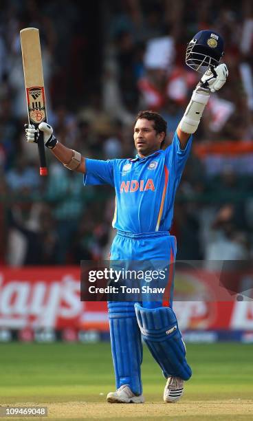 Sachin Tendulkar of India celebrates reaching his century during the 2011 ICC World Cup Group B match between India and England at M. Chinnaswamy...