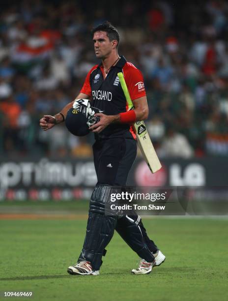 Kevin Pietersen of England walks off after his dismissal during the 2011 ICC World Cup Group B match between India and England at M. Chinnaswamy...