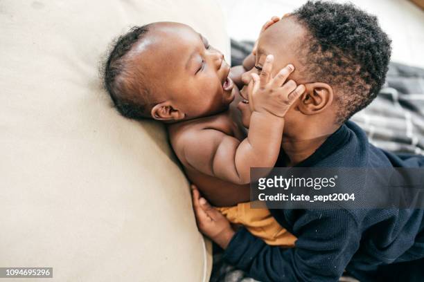 siblings playing together - sibling stock pictures, royalty-free photos & images