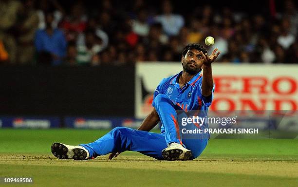 Indian cricketer Munaf Patel takes a catch to dismiss England batsman Kevin Pietersen during the ICC Cricket World Cup 2011 match between England and...