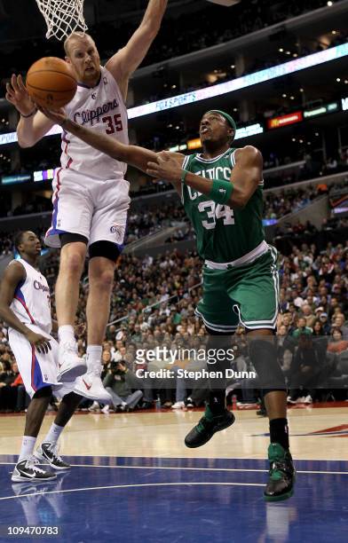 Paul Pierce of the Boston Celtics pus up a shot around Chris Kaman of the Los Angeles Clippers at Staples Center on February 26, 2011 in Los Angeles,...