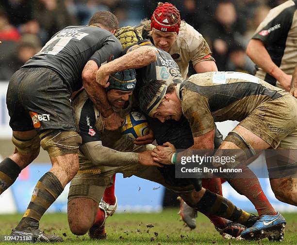 Marty Veale and Richard Birkett of Wasps tackle Schalk Brits of Saracens during the AVIVA Premiership match between London Wasps v Gloucester Rugby...