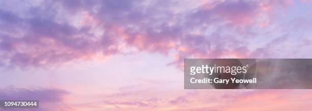 panoramic view of pink clouds in sky at sunset - wolkengebilde stock-fotos und bilder