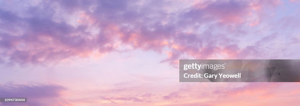 Panoramic view of pink clouds in sky at sunset