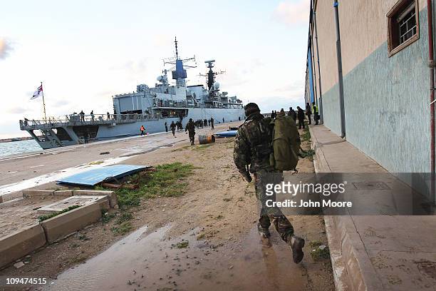 British marine prepares to board the HMS Cumberland at sunset on February 27, 2011 at the port in Benghazi, Libya. The Cumberland evacuated more...