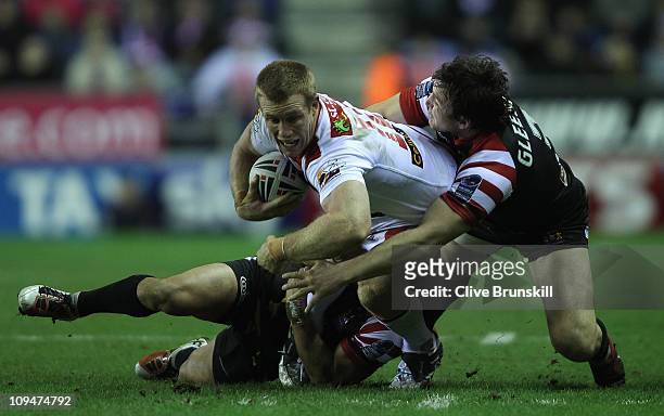 Ben Creagh of St George Illawarra Dragons is tackled by Martin Gleeson of Wigan Warriors during the World Club Challenge match between Wigan Warriors...