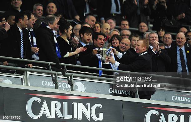Alex McLeish, Manager of Birmingham City holds the trophy with Hong Kong owner Carson Yeung after the Carling Cup Final between Arsenal and...