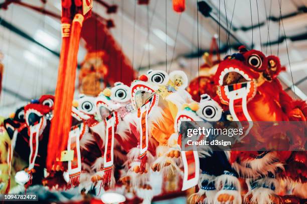 colourful lion dance chinese new year decorations and ornaments for sale in street vendor stalls - hong kong celebrates chinese new year stock pictures, royalty-free photos & images