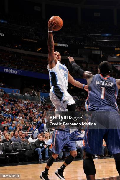 Jameer Nelson of the Orlando Magic shoots against Stephen Jackson of the Charlotte Bobcats during the game on February 27, 2011 at the Amway Center...