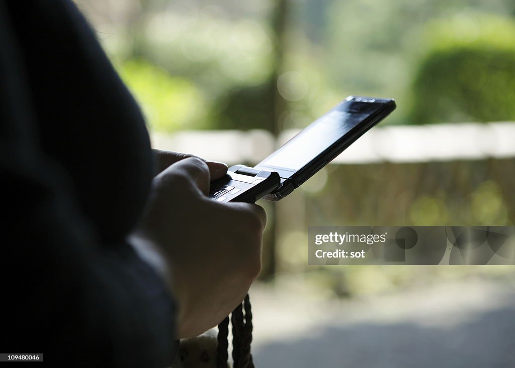 Woman using mobile phone,close up