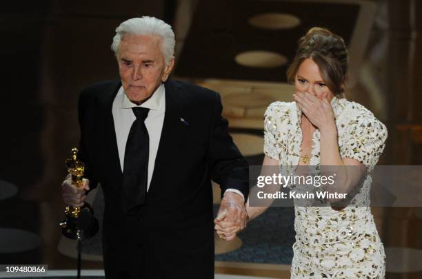 Presenter Kirk Douglas shakes hands with actress Melissa Leo after Leo won the Actress in a Supporting Role award for "The Fighter' onstage during...