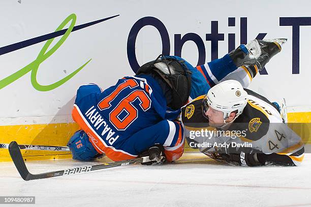 Magnus Paajarvi of the Edmonton Oilers is upended after a collision with Dennis Seidenberg of the Boston Bruins at Rexall Place on February 27, 2011...