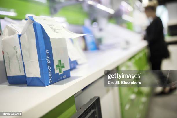 Bags of completed medical prescriptions sit on the counter and await collection by customers from Hodgson Pharmacy in Longfield, Kent, U.K., on...