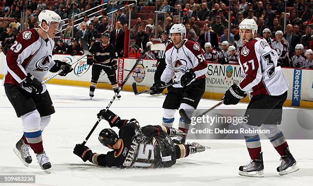 Ryan Getzlaf of the Anaheim Ducks is knocked to the ice defending against Ryan Stoa, David Jones and Ryan O'Reilly of the Colorado Avalanche during...