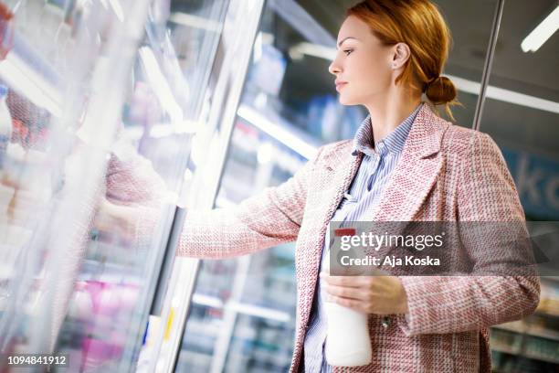 milk is an excellent source of calcium, i'll take two. - refrigerated section supermarket stock pictures, royalty-free photos & images