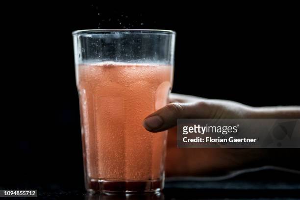 In this photo illustration a female person takes a glas of chalybeate water on February 05, 2019 in Berlin, Germany.
