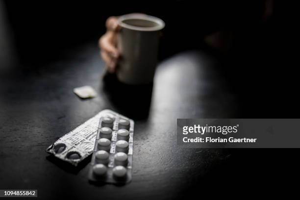 In this photo illustration tablets are pictured in front of a cup of tea on February 05, 2019 in Berlin, Germany.