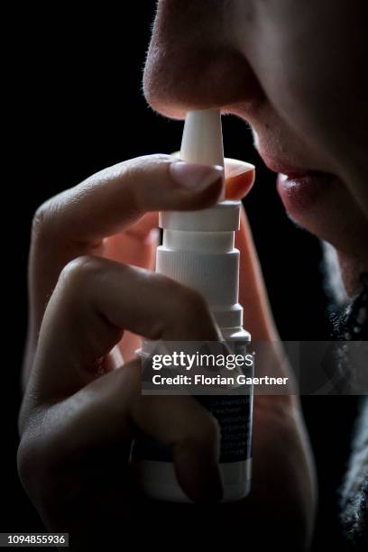 In this photo illustration a sich woman uses nasal spray on February 05, 2019 in Berlin, Germany.