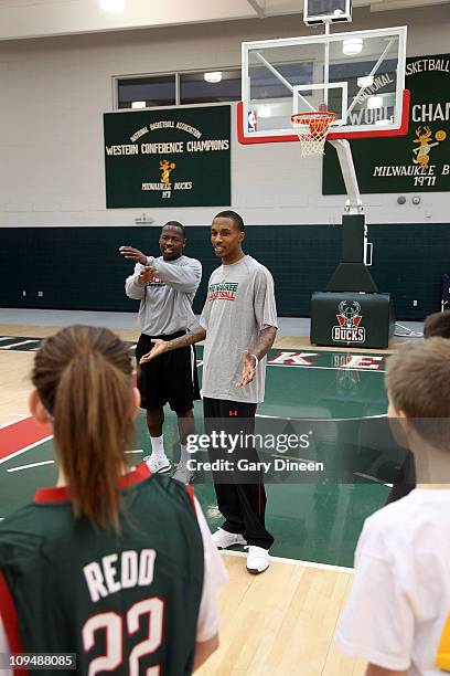 Milwaukee Bucks assistant coach Anthony Goldwire and guard Brandon Jennings work with participants during the YMCA basketball clinic on February 27,...