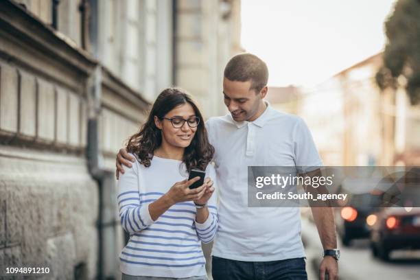 Photo Walk Using Phone Couple Walking On Phone Photos and Premium High Res Pictures - Getty Images