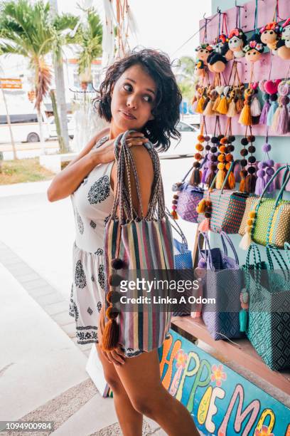 Girl Checking out a Purse in front of Boutique Store