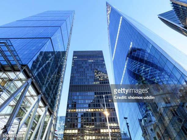 law angle view of futuristic london skyscrapers - multiple exposure - skyscraper stock pictures, royalty-free photos & images