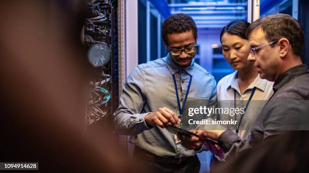 it engineers using digital tablet - computer server room stock pictures, royalty-free photos & images