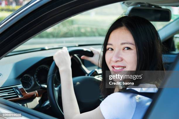 beautiful woman smiling and driving a car - drive atividade desportiva imagens e fotografias de stock