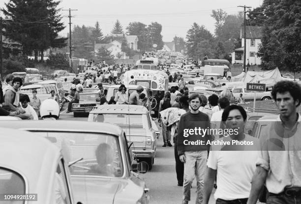 Festival-goers abandon their vehicles in a traffic jam on the way to the Woodstock Music Festival, Bethel, New York, 15th August 1969. At centre is a...