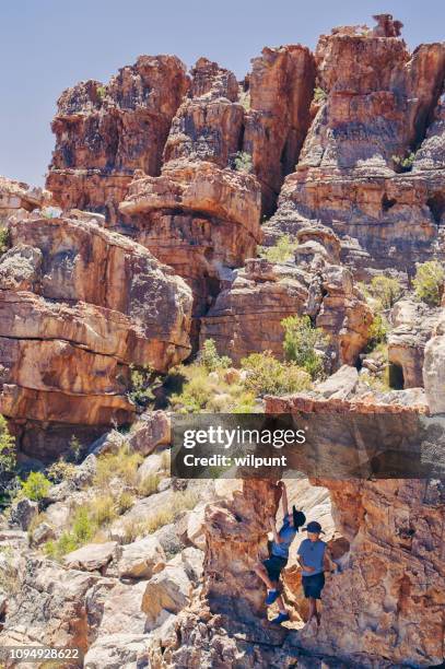 two brothers climbing free - caving stock pictures, royalty-free photos & images