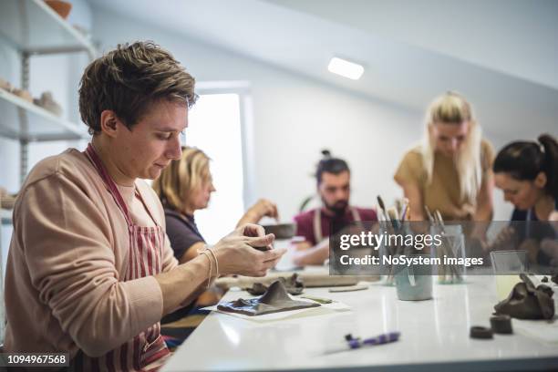 group of people learning ceramic art - art class stock pictures, royalty-free photos & images