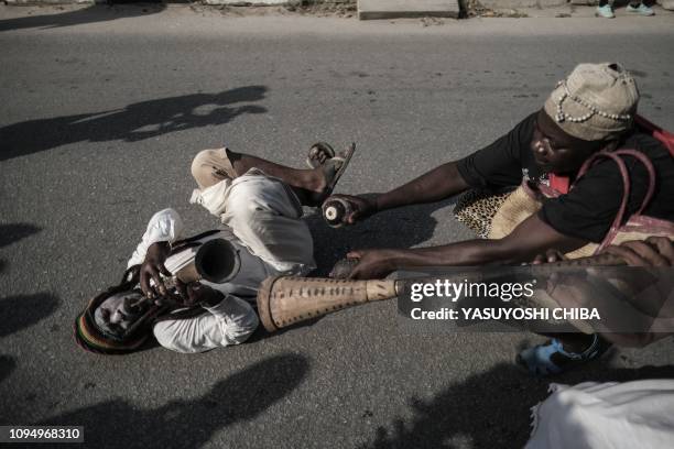 Performers parade through the street to kick off the 16th International African music festival "Sauti za Busara in Stone town on Tanzanias...