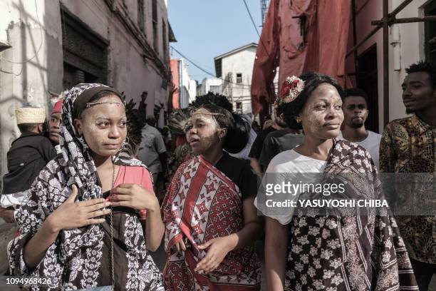 Performers parade through the street to kick off the 16th International African music festival "Sauti za Busara in Stone town on Tanzanias...