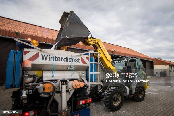 An employee of the road maintenance depot works with a wheel loader in a salt storage on February 07, 2019 in Birkenwerder, Germany.