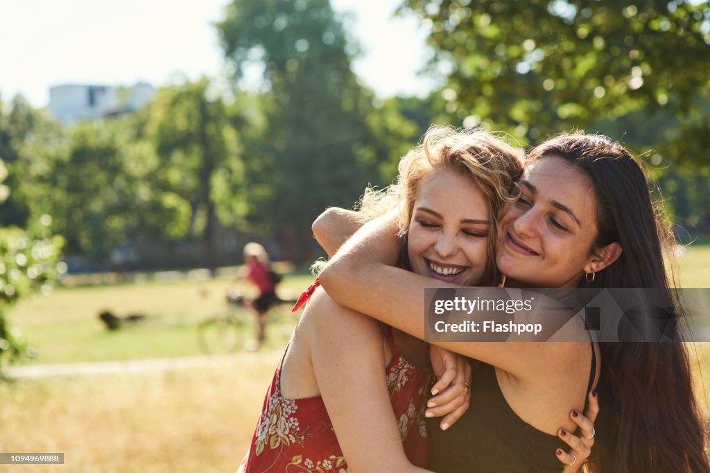 Two young women embracing each other lovingly